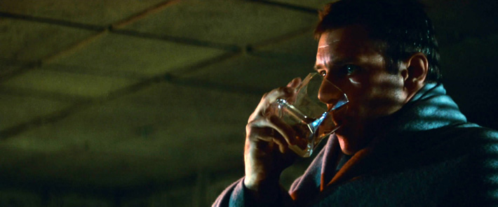 Deckard drinking out of the glass.